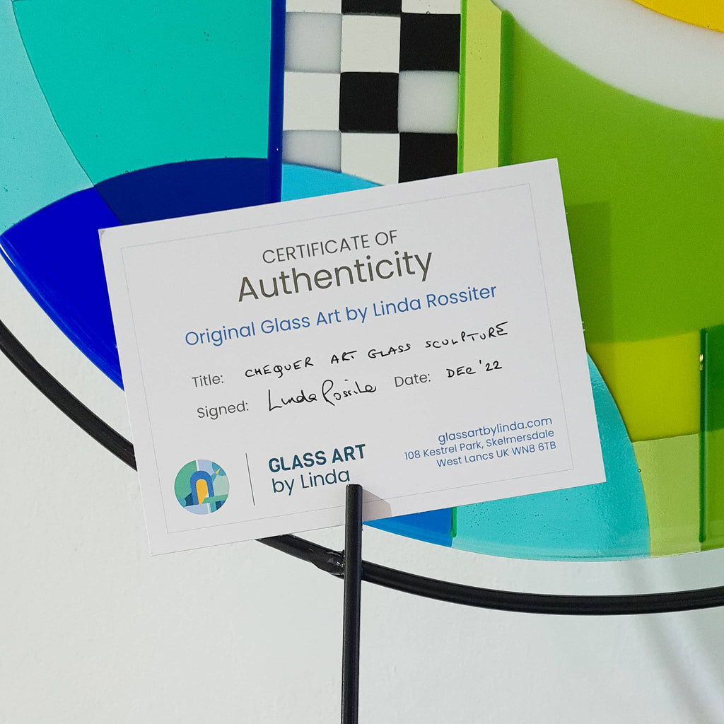 Certificate of Authenticity for the Chequer large round fused glass art sculpture. Fused glass artwork in rainbow colours in a Hard Edge glass art style