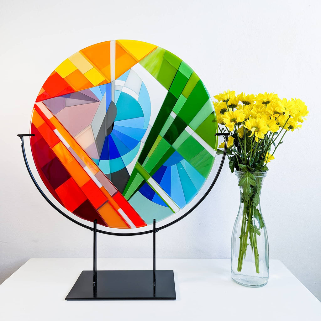 Stairs large round fused glass art sculpture by Glass Art by Linda. Unique glass roundel in rainbow colours in a Hard Edge glass art style